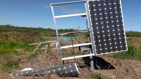 A damaged solar panel with one of the arrays on the ground.