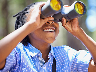 A young boy with a pair of binoculars