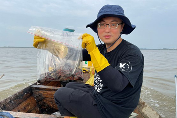 China Program staff holding crayfish samples.